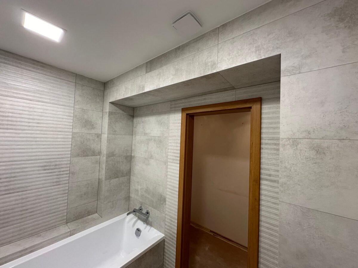 Krásná moderní koupelna v šedých barvách s velkou vanou a samostatným WC (Most)